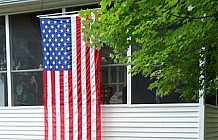 American Flag And Red Flowers